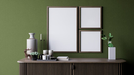A modern interior scene featuring a green wall, decorative empty frames, a vase, candles, and small plants on a stylish wooden console table. 3d rendering.