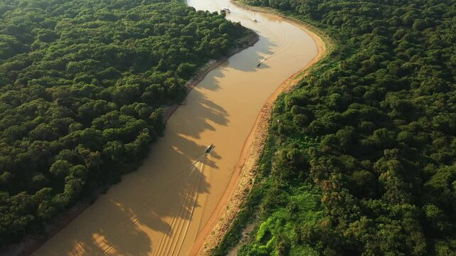 Boats sailing on the Tonle Sap River in the lush jungle in Asia, Cambodia, towards Siem Reap, in summer on a sunny day. 