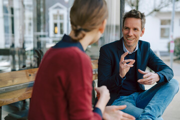 Two people having a business discussion at a caf� outdoors