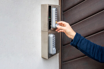 Woman using a key safe for self check-in at a holiday accommodation
