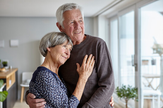 Happy couple embracing at home with a sense of love and trust