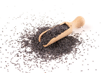 Black poppy seeds in a wooden spoon (scoop) on a white insulated background.