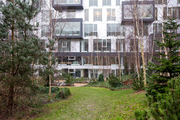 Modern urban path between residential buildings with minimalist landscaping in Copenhagen, with clean geometry and natural light, ideal for copyspace and commercial design.