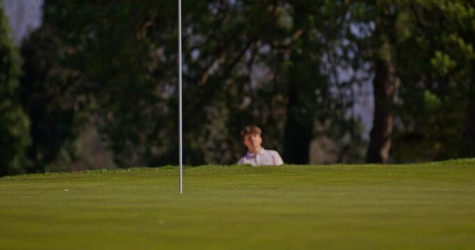 Young golfer playing on a sunny spring day in Switzerland, showcasing precise chipping, putting, bunker, and approach shots. Perfect for sports, lifestyle, and outdoor themes.