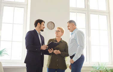 Senior couple talking to real estate agent, clients consulting broker about house plan, project selling, buying new flat terms, investment, meeting discussing property plan, contract with lawyer