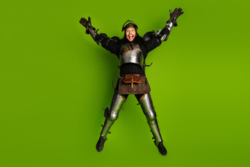 Man in medieval armor joyfully jumping with green background symbolizing modern twist on classic knight attire