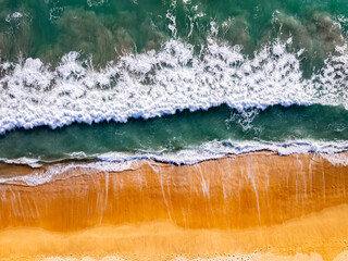 Top view beach waves nature background,Amazing waves crashing on sandy shore seascape view
