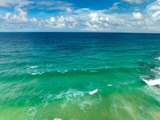 Fototapeta premium Aerial view beautiful sea surface nature background,Amazing waves texture ocean with clouds