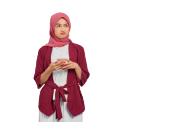 Unhappy young Asian Muslim woman in hijab holding smartphone with annoyed facial expression isolated on transparent background