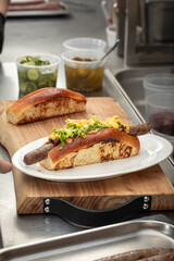 Preparing appetizing hot dogs in american diner kitchen counter