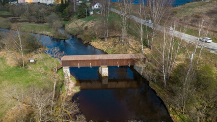 The picturesque covered wooden bridge Rechle near Lenora in the Šumava mountains – a unique national cultural monument - historic bridge with a wooden deck and stone pillars