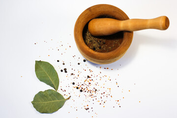 minimalistic photo of spices and wooden mortar for grinding spices on white background