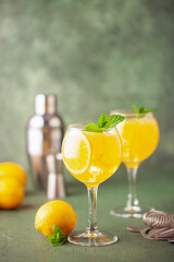 Homemade Limoncello spritz drink of liqueur, sparkling wine and lemon in cocktail glass