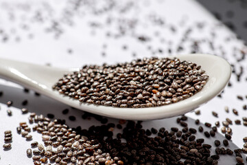 organic chia seeds on a white background, supporting immunity and enriching the diet with useful microelements. healthy lifestyle concept, cooking, nutrition.