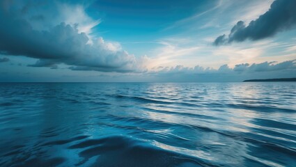 Fototapeta premium Rain-soaked asphalt road with lake and blue sky overhead.