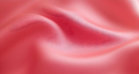 Fototapeta premium Close-up of smooth, flowing pink fabric showcasing soft textures and elegant draping, perfect for fashion, interior design, and aesthetic projects.
