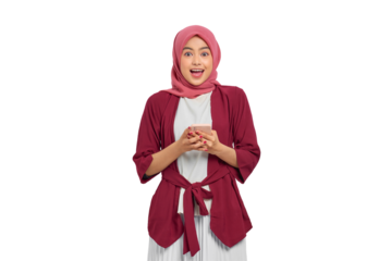 Happy young Asian Muslim woman in hijab holding smartphone and smiling with excitement isolated on transparent background