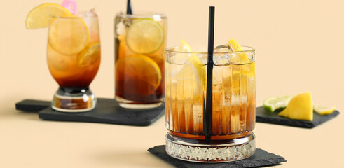 Glasses of delicious Long Island iced tea on color background