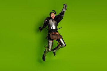 Energetic portrayal of a medieval armored man against a bright green backdrop, celebrating in motion