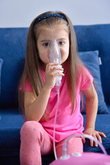 Little girl with pink pig inhaler