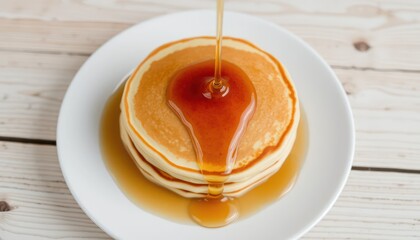 Stacked pancakes drizzled with syrup