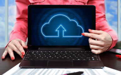 Businesswoman in office and laptop with cloud computing interface.