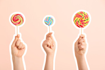 Hands with sweet lollipops on color background