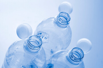Plastic bottles with so-called tethered caps in monochrome blue. The caps are attached to the drink bottle to prevent it from ending up in nature. The EU bans loose closures and caps on bottles.