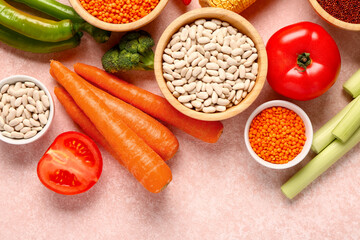 Different fresh vegetables and cereals on pink background, closeup