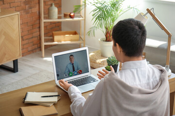 Young man having job interview online at home