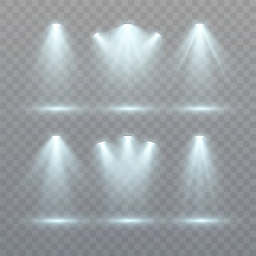 A set of directional white spotlights with realistic light beams on a transparent background for stage lighting, digital mockups and user interfaces.