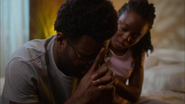 Family support African American ethnic married couple relationship problems caring woman wife apologizing after fight ask forgiveness quarrel calming depressed husband man at home bedroom late evening