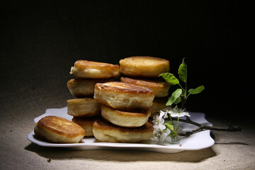 Still life with pancakes on a white plate