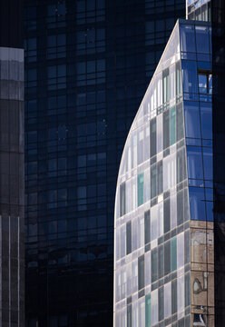 Architectural contrast of modern glass and dark metal buildings in New York