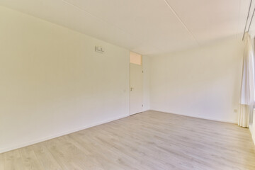 A spacious and bright interior showcasing minimalist design with light-colored walls and wooden flooring, perfect for modern living aesthetics.