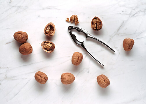Walnuts and Nutcracker on a Marble Surface in Natural Light