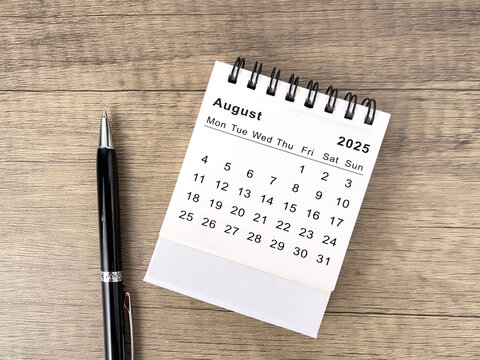 2025 August desk calendar flat lay on wooden table 