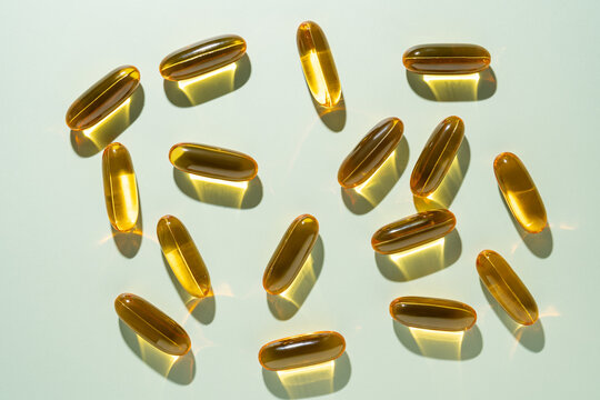 Top view of Omega 3 capsules arranged on a light surface
