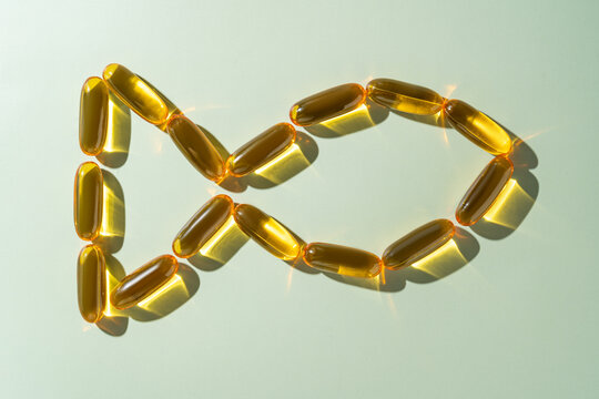 Top view of arranged Omega 3 capsules forming a loop