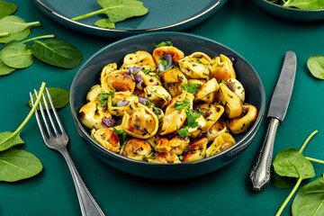 A plate of ravioli filled with a green spinach.