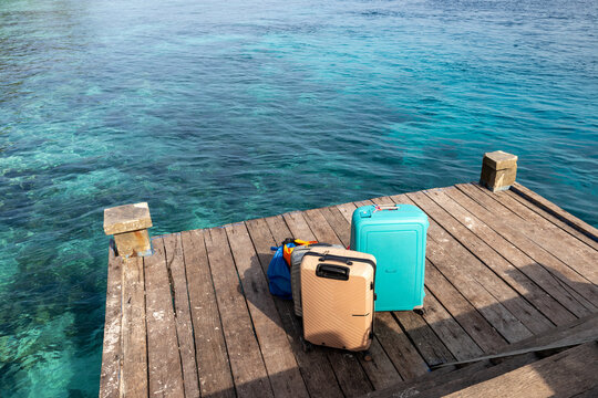 Luggage on a wooden pier at Kri Island, Raja Ampat