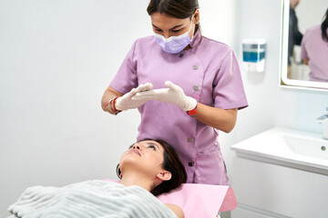 Beauty Therapist Preparing for Facial Treatment with Client