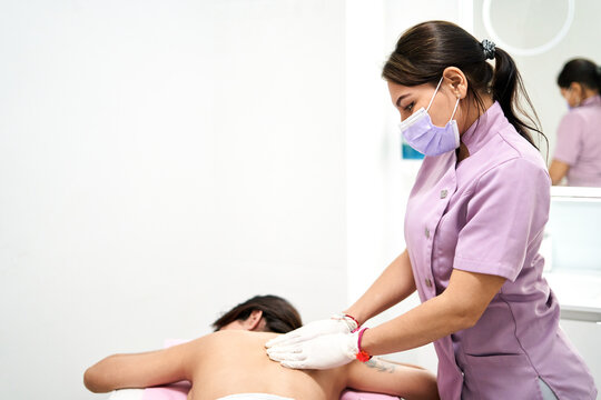 A therapist provides a massage to a client in a serene beauty salon