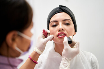 Close-Up of Precise Lipstick Application by Beauty Therapist