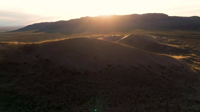 Dune on a sunset, windy weather, drone view
