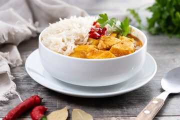 Massaman curry in bowl on wooden table. Traditional Thai food recipe.