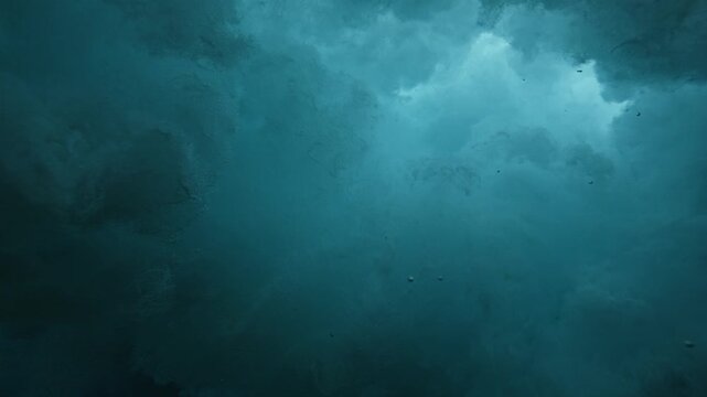 Underwater push and pull power and turbulence as wave crashes over shoreline