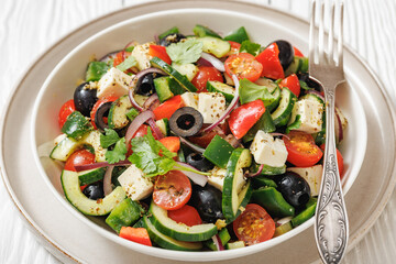 greek salad of veggies, olives, cheese in bowl