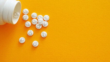 Testosterone hormone therapy. Hormone replacement therapy HRT. Masculinizing hormone treatment. Pills with male symbol and Medical hormone