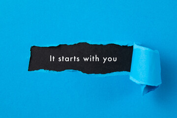 torn paper background with it starts with you message